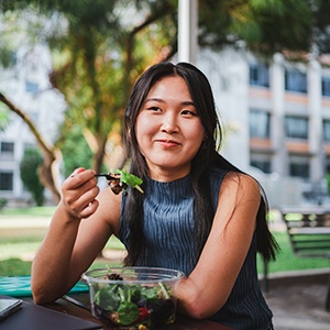 Patient in Raleigh eating healthy with dental implants