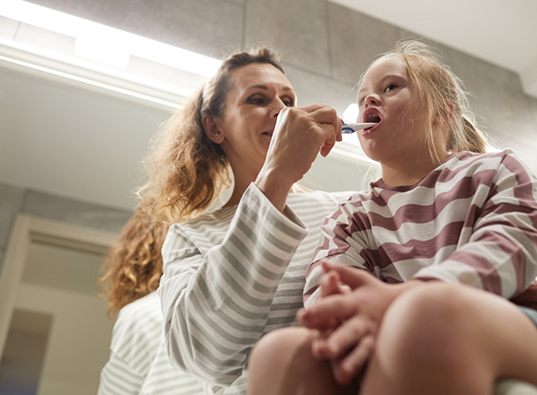 Dentist giving a young girl a dental cleaning