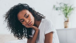 Woman holding the side of her face in pain