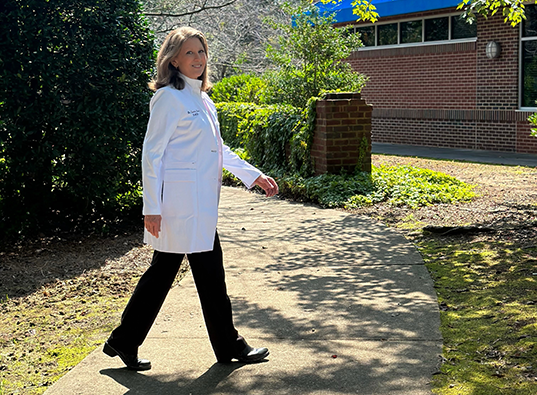 Raleigh dentist Doctor Sandra Thore walking in front of Falls Family Dental